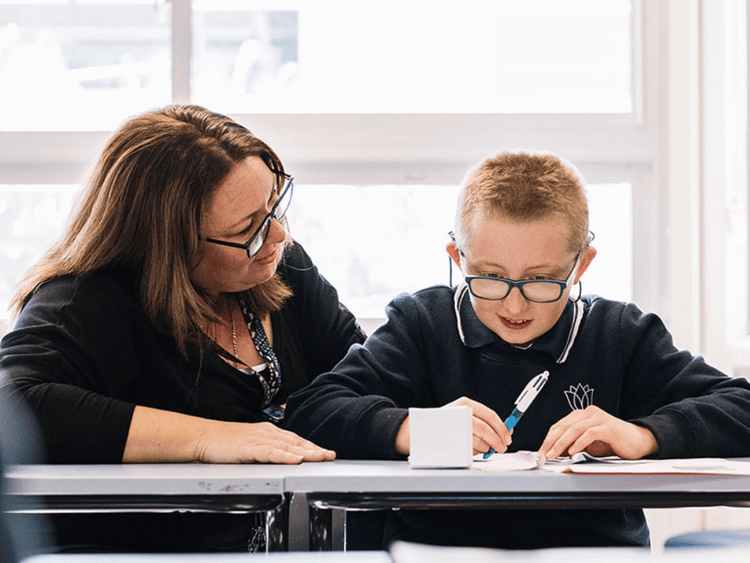A female slso supporting a male student in class