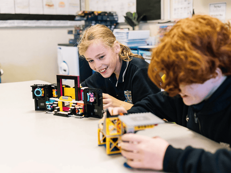 Two students building with lego blocks